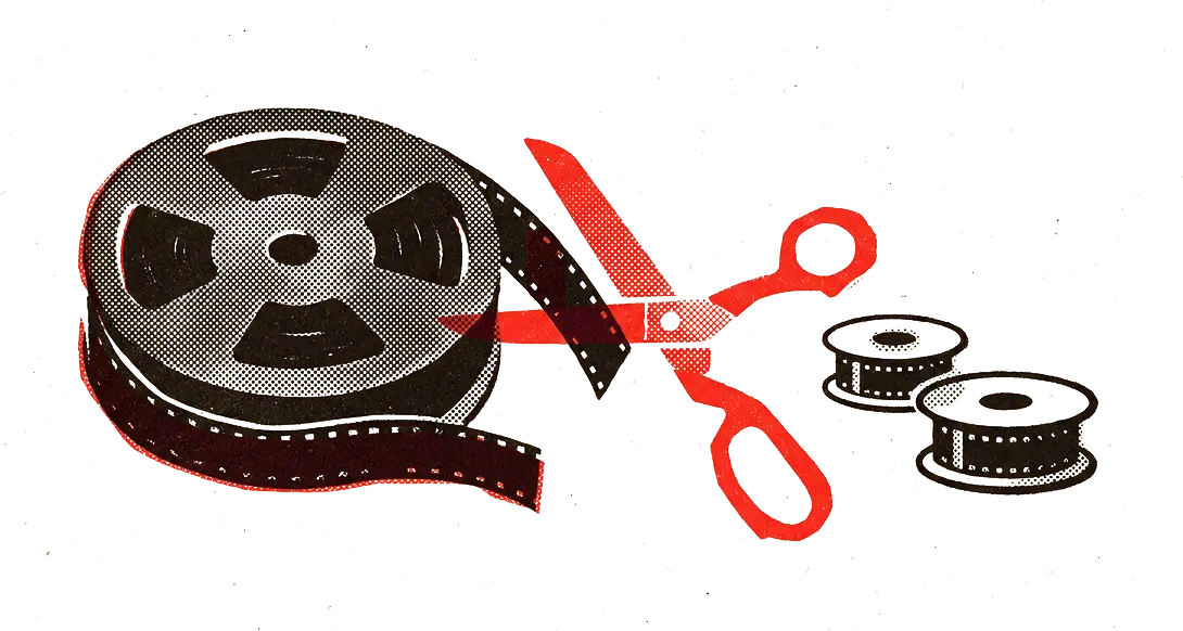 A large full film reel, a pair of red scissors mid-cut, and two small tidy spools